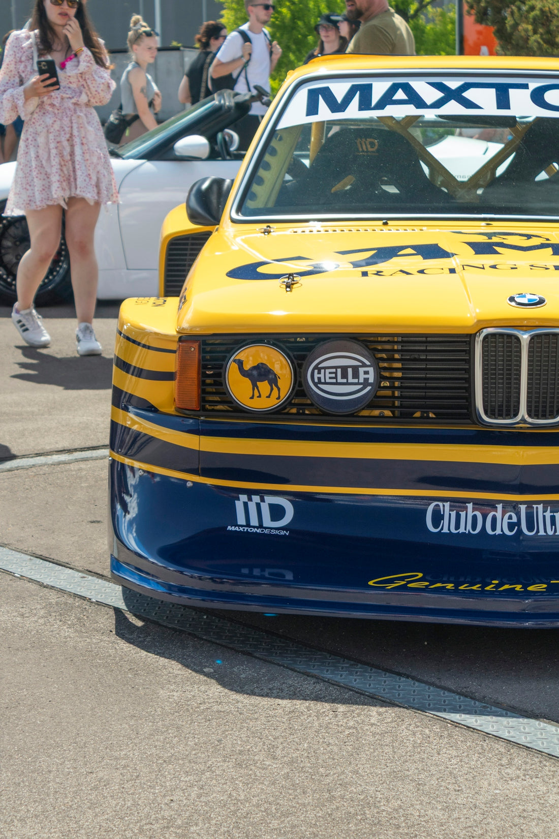 Yellow racing car with blue stripes and camel logo